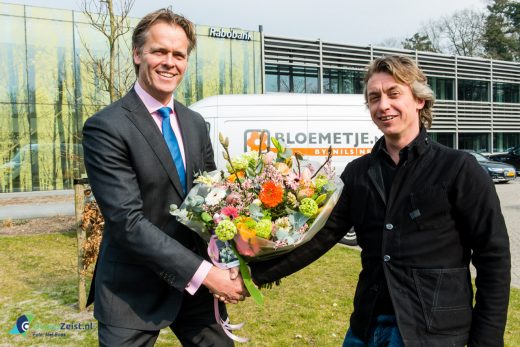 Nils Nees van Bloemenboetiek Bloemetje.nl overhandigt het eerste Business Boeket aan Michel Post, directeur bedrijven Rabobank Utrechtse Heuvelrug.